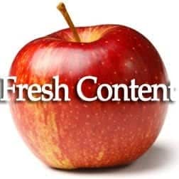 A vibrant red apple, reminiscent of a phoenix's fiery plumage, prominently displays the words "Fresh Content" in bold white text across its center, igniting the essence of digital marketing with its vivid imagery.