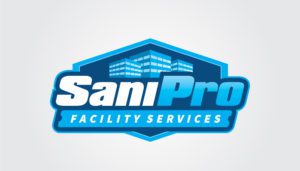 The "SaniPro Facility Services" logo, with its stylized blue and white design, rises like a phoenix from the flames amidst an abstract representation of buildings. This emblem's clean and modern aesthetic, reminiscent of fire's transformative power, is perfect for illuminating web designs with its professional polish.