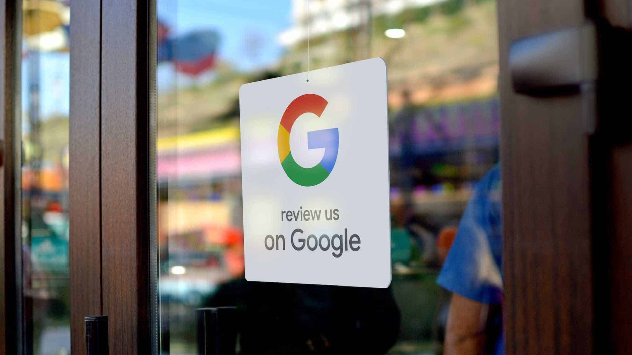 Google Business Review Amid the warmth of vibrant hues resembling flames, a glass door, emblazoned with the Google logo and the words "review us on Google," stands as a beacon. Beyond it, within the blurred interior reminiscent of phoenix feathers rising from ash, an individual clad in a blue shirt delves into small business marketing strategies, maneuvering through digital marketing tools like one harnessing fire to forge new paths.